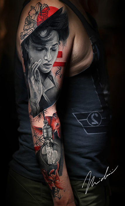 tattoo arm sleeve featuring a singer and red flowers